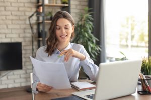 happy-entrepreneur-woman-sit-desk-reading-good-news-post-paper-correspondence