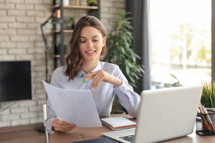 happy-entrepreneur-woman-sit-desk-reading-good-news-post-paper-correspondence